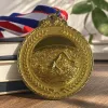 The golden circular swimmer's medal with olive branch pattern is adorned with a hanging ring details Picture